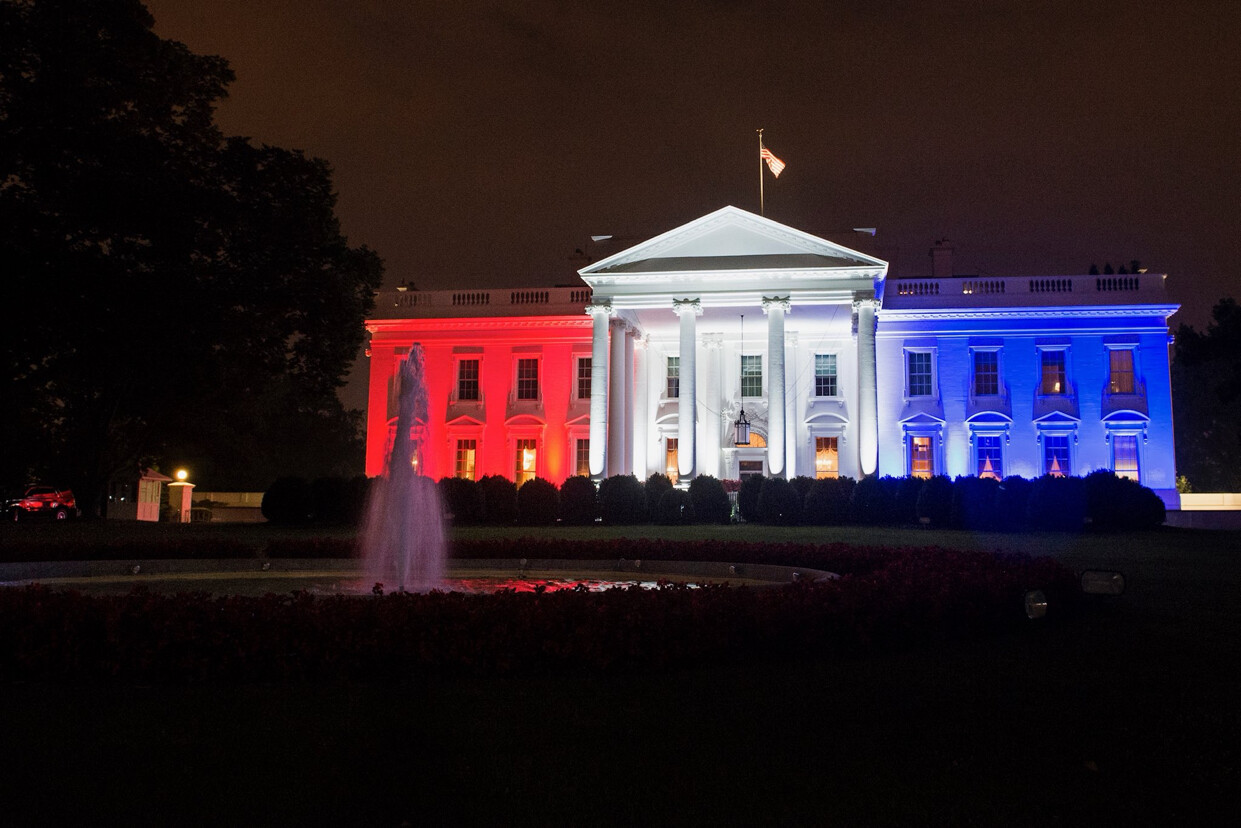 picture of the White House colored in red, white, and blue lights