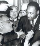 LBJ shaking hands with Martin Luther King after signing the civil rights act.